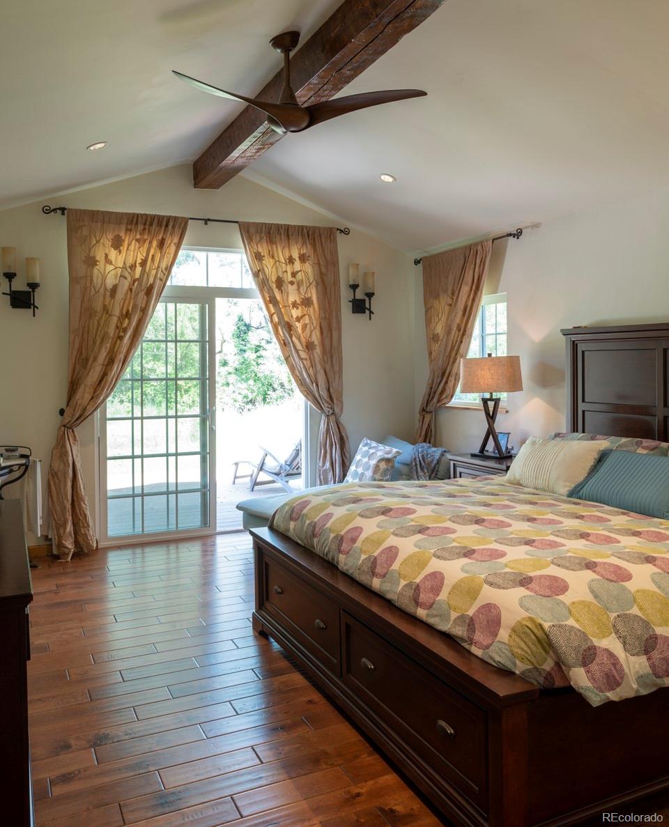 1085 Gapter Road Boulder, CO 80303 - Photo 17 of 24 a bed sitting in a spacious bedroom next to a window