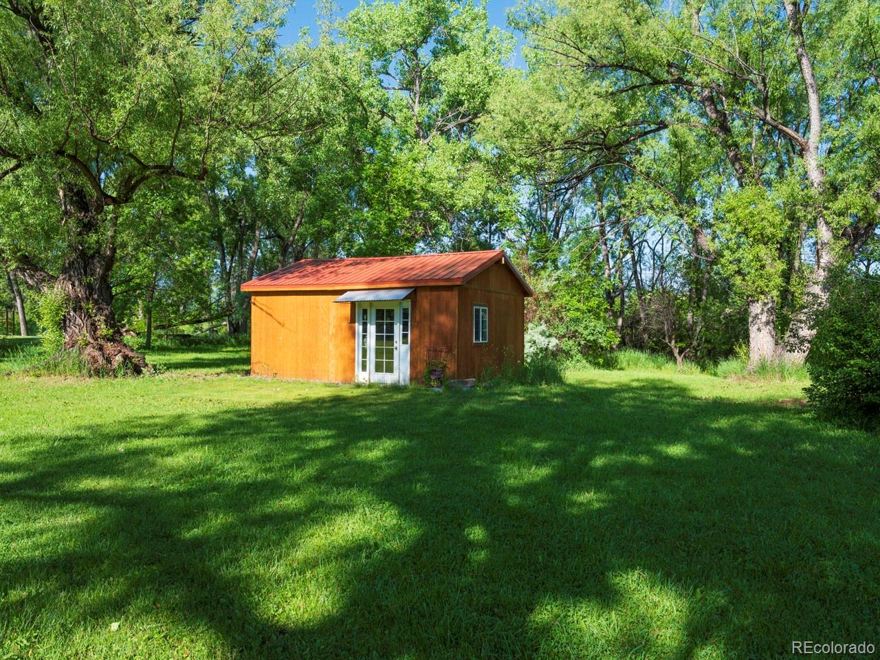 1085 Gapter Road Boulder, CO 80303 - Photo 20 of 24 a view of a backyard with large trees