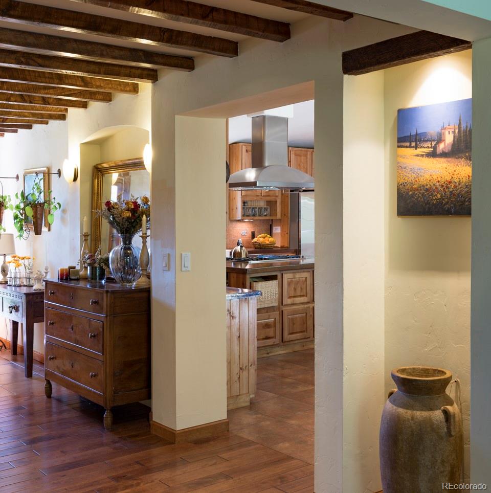 1085 Gapter Road Boulder, CO 80303 - Photo 7 of 24 a view of a hallway with wooden floor and furniture