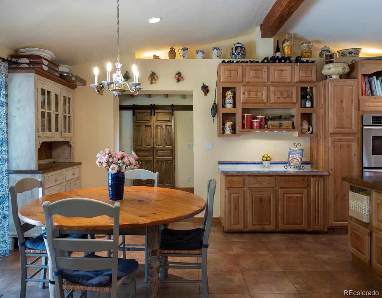 1085 Gapter Road Boulder, CO 80303 - Photo 9 of 24 a dining table with chairs and chandelier
