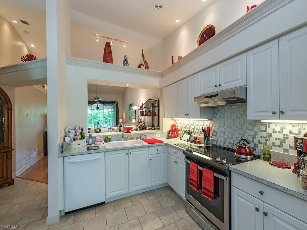 1827 West Crown Pointe Boulevard Naples, FL 34112 - Photo 5 of 12 a kitchen that has a lot of cabinets and appliances