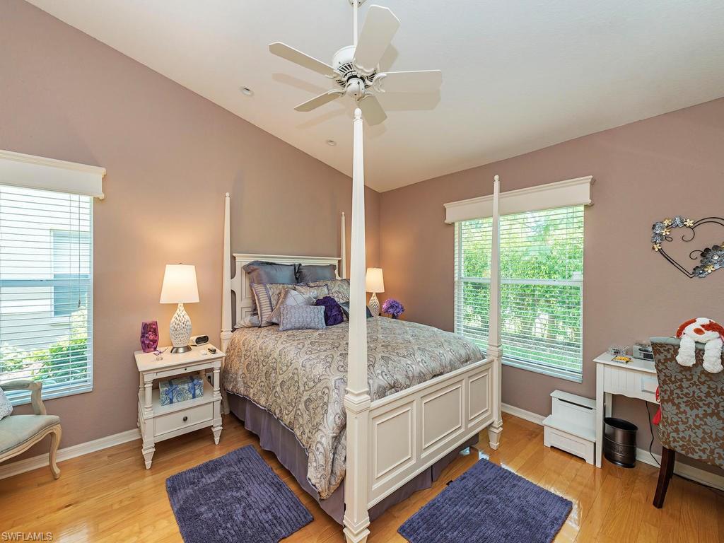 1827 West Crown Pointe Boulevard Naples, FL 34112 - Photo 7 of 12 a bedroom with a bed and a table