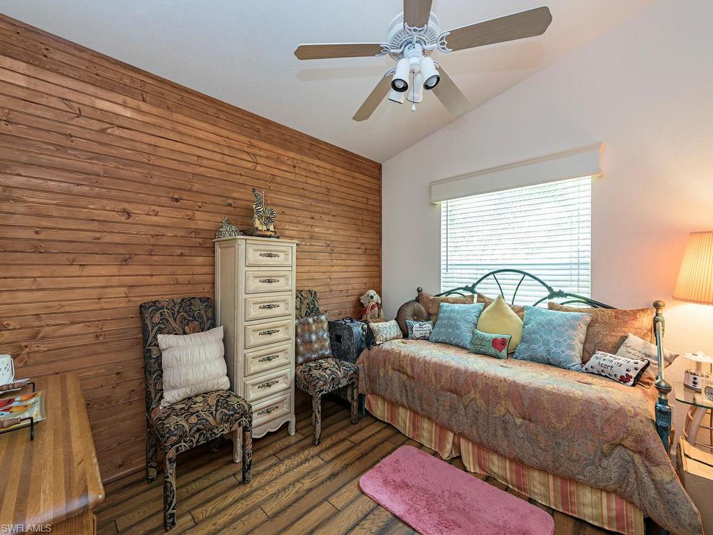 1827 West Crown Pointe Boulevard Naples, FL 34112 - Photo 9 of 12 a bedroom with a bed dresser and a window