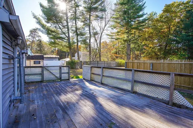a view of outdoor space with deck and wooden fence