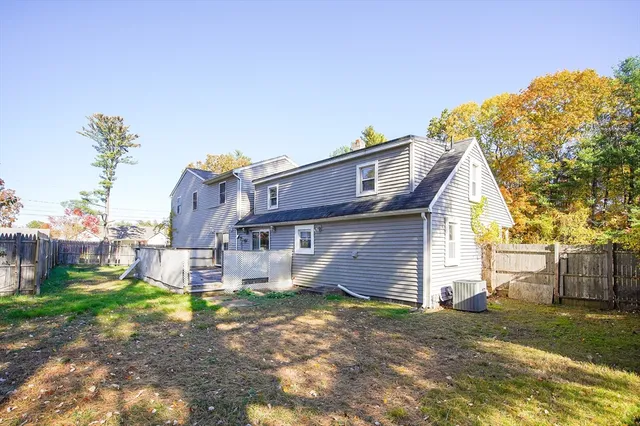 a view of a house with a backyard