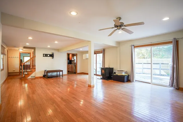 a view of a living room and kitchen with furniture wooden floor and windows