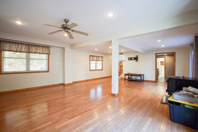 a view of a livingroom with hardwood floor and a ceiling fan
