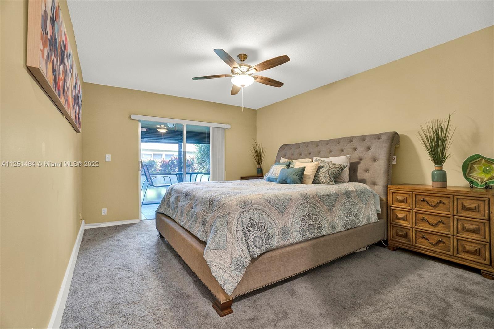 Whisper Walk Boca Raton, FL 33496 - Photo 5 of 17 a bedroom with a bed and a chandelier