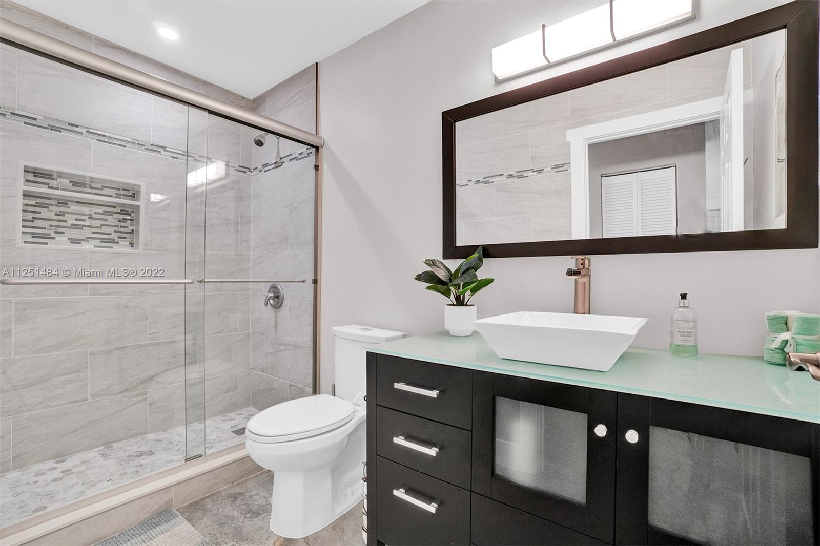 Whisper Walk Boca Raton, FL 33496 - Photo 8 of 17 a bathroom with a sink a toilet and shower