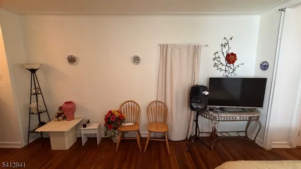a view of a workspace with furniture and wooden floor
