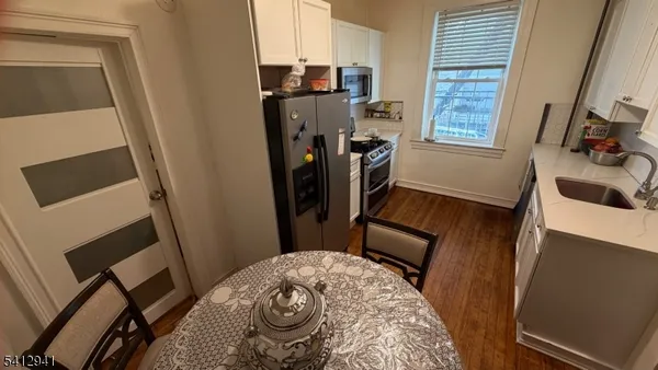 a view of a livingroom with furniture and a window