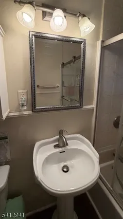 a bathroom with a sink and mirror
