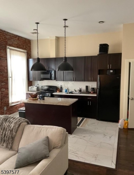 518 South Main Street, Unit 6 Phillipsburg, NJ 08865 - Photo 6 of 10 a living room with stainless steel appliances kitchen island granite countertop furniture and a wooden floor