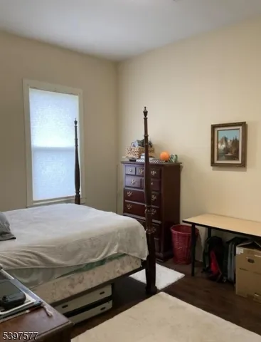 a bedroom with a bed a desk and chair