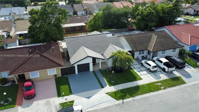 an aerial view of a house with garden space and sitting area