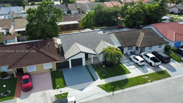 an aerial view of a house with garden space and sitting area