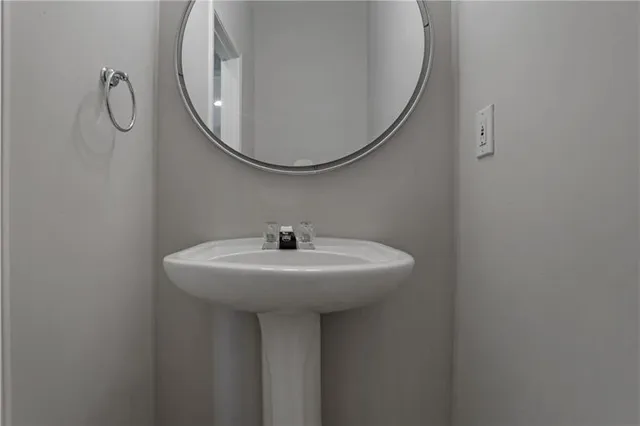 a bathroom with a sink a mirror and a shower