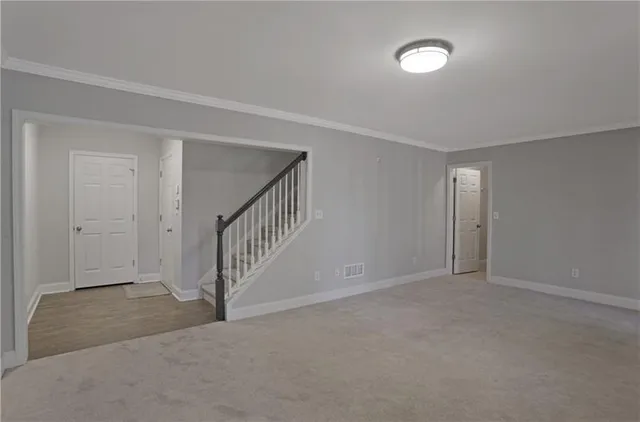 a view of an empty room with stairs