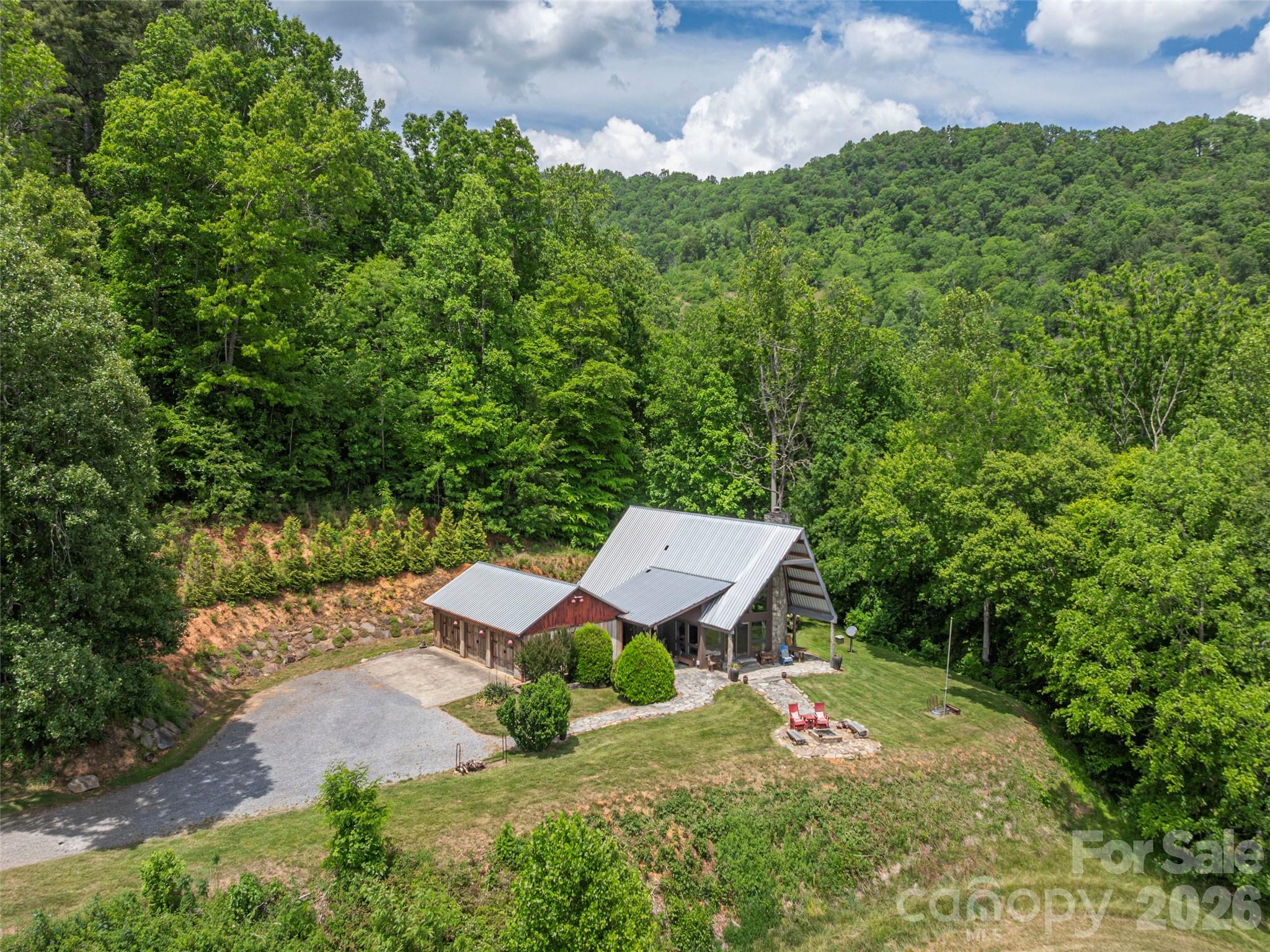 461 Ferguson Cove Loop Clyde, NC 28721 - Photo 40 of 46 an aerial view of a house with a yard and lake view