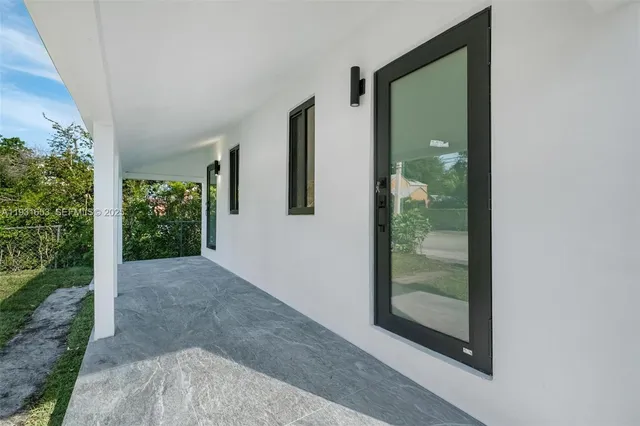 a view of a bathroom with a glass door and garden