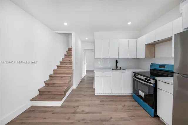 a kitchen with granite countertop a stove and a sink