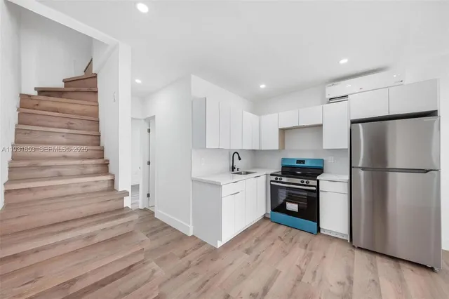 a kitchen with cabinets and stainless steel appliances