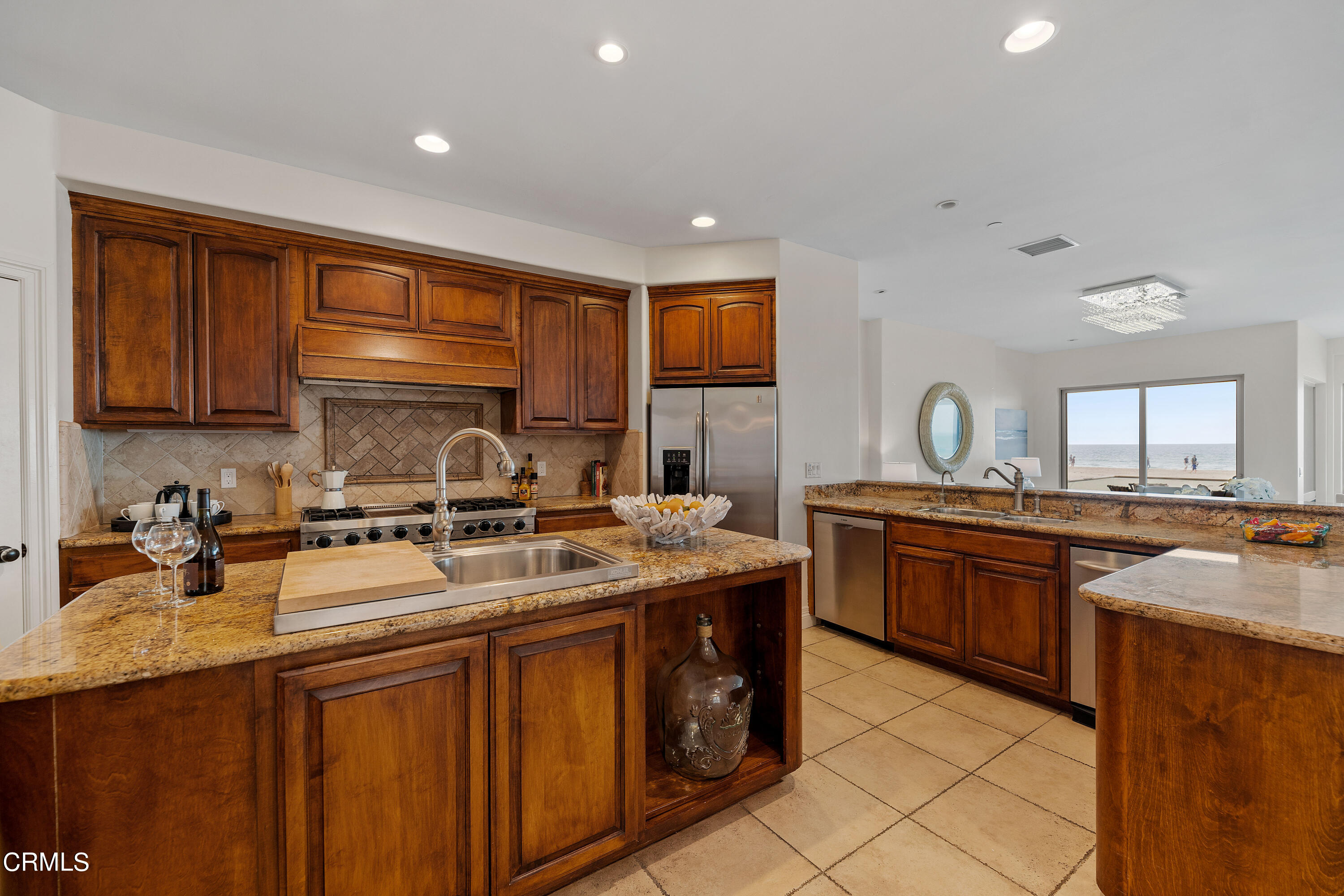 1065 Mandalay Beach Road Oxnard, CA 93035 - Photo 13 of 36 a kitchen with stainless steel appliances granite countertop a sink stove and cabinets