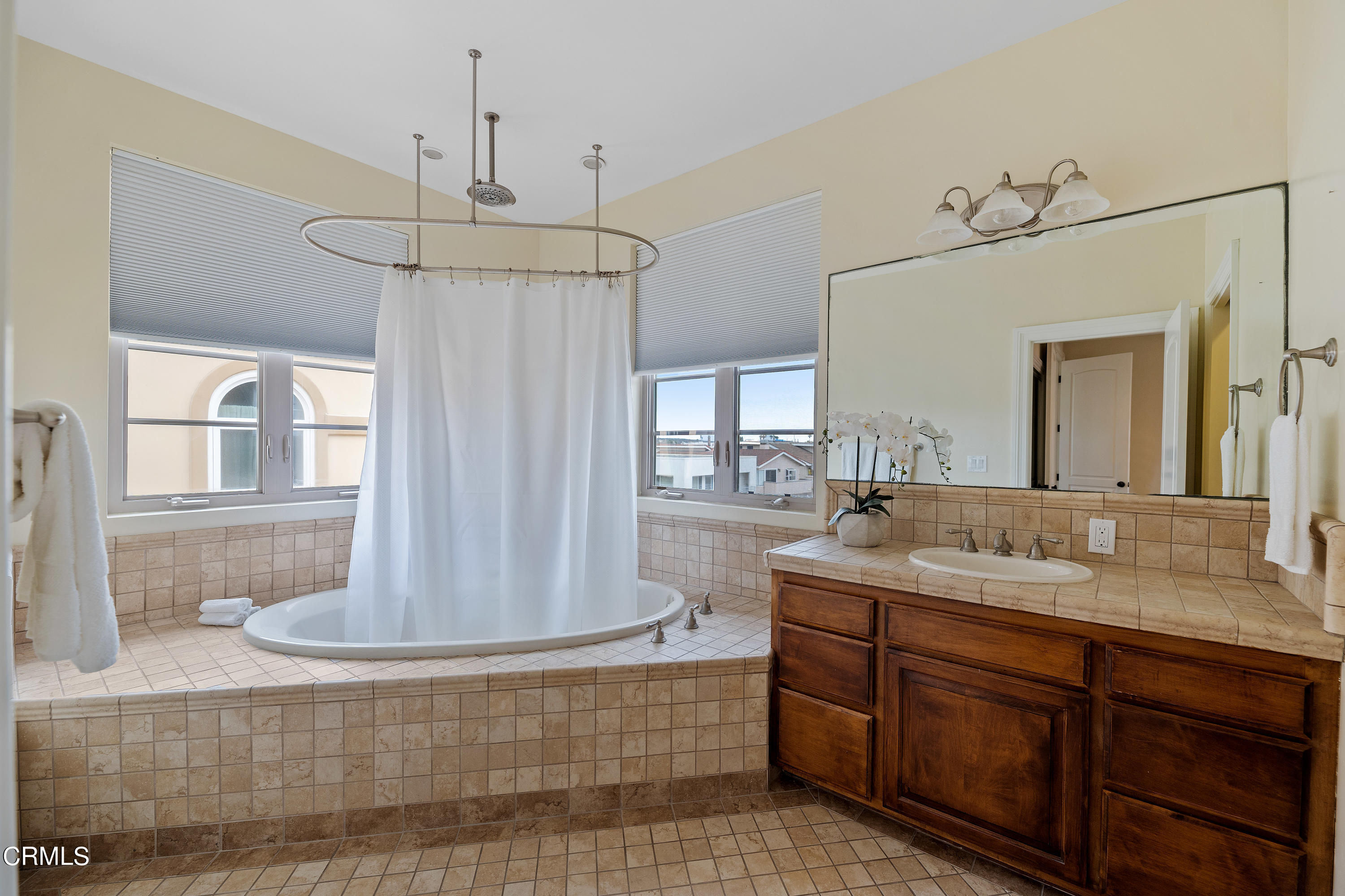 1065 Mandalay Beach Road Oxnard, CA 93035 - Photo 30 of 36 a bathroom with a granite countertop sink a mirror and shower
