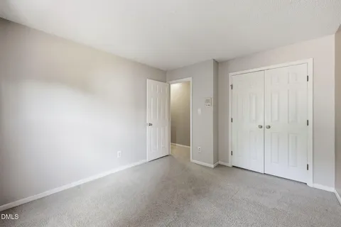 a view of an empty room with a ceiling fan