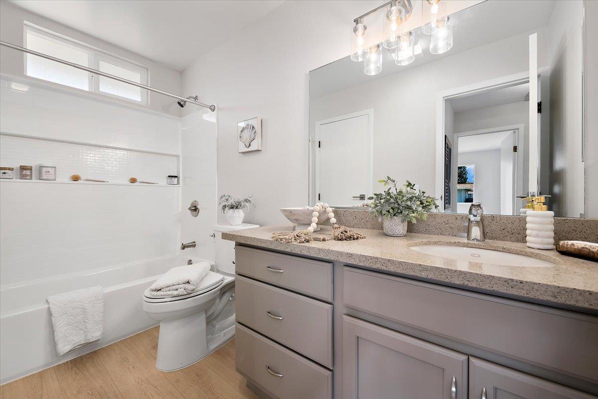 1093 Reed Avenue, Unit C Sunnyvale, CA 94086 - Photo 10 of 16 a bathroom with a granite countertop sink a toilet and a bathtub