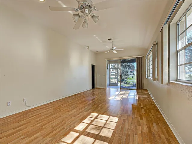 a kitchen with a sink a microwave and cabinets