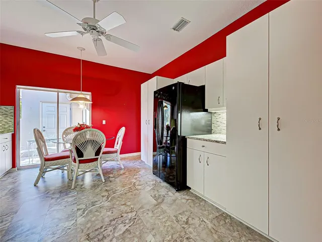a bedroom with two beds and a ceiling fan