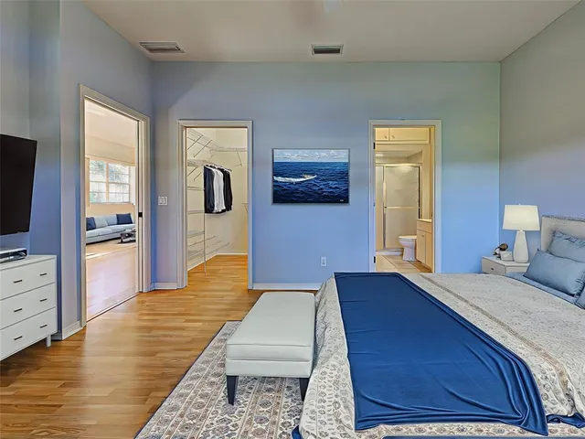 a bedroom with a bed and a chandelier