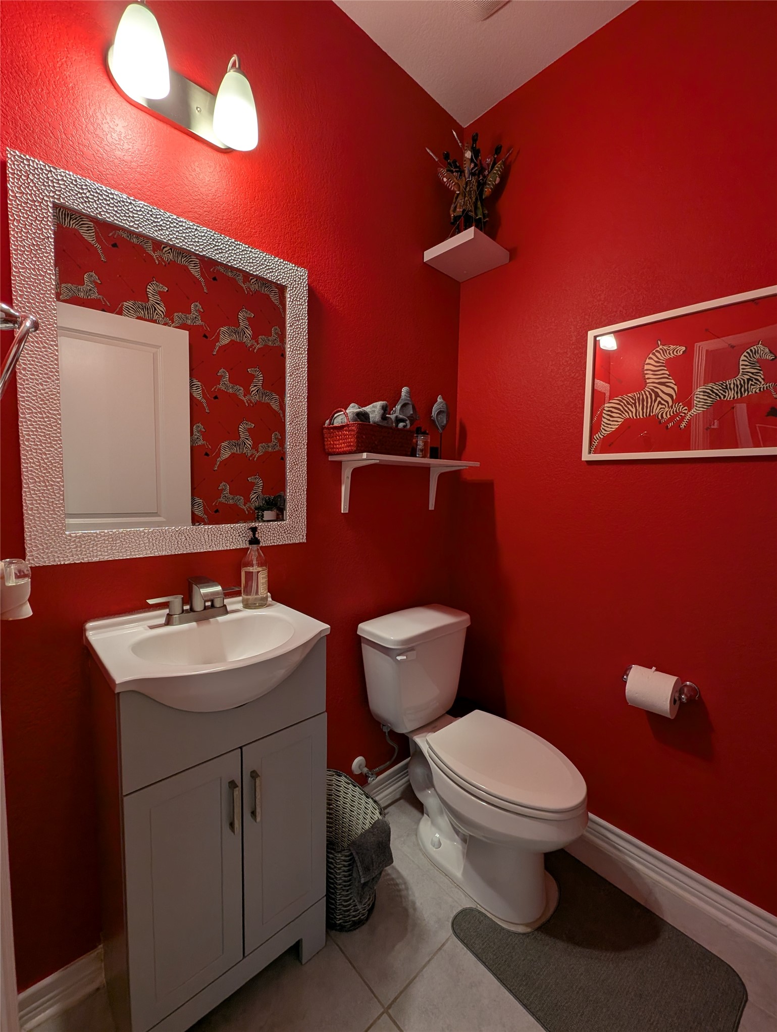 14502 McCoy Loop Austin, TX 78717 - Photo 23 of 26 Compact bathroom featuring a contemporary vanity with an integrated sink, polished chrome faucet, and a decorative framed mirror