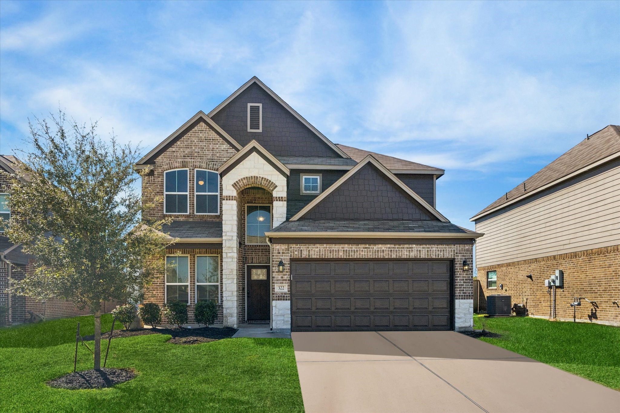 a front view of a house with a yard and garage
