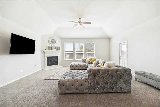 a living room with fireplace furniture and a flat screen tv