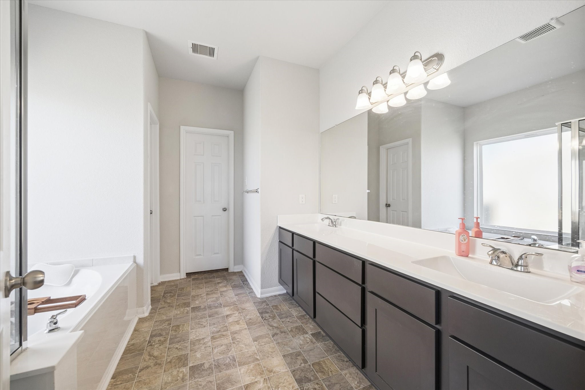 322 Upland Grv Trail Rosharon, TX 77583 - Photo 22 of 36 a spacious bathroom with a double vanity sink mirror and a bathtub