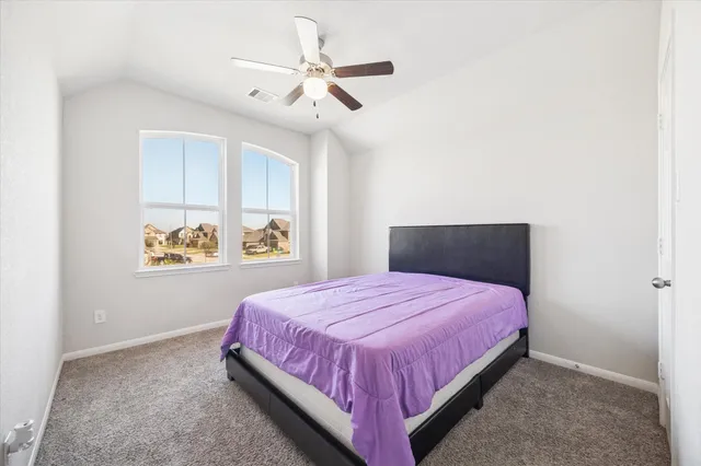 a bedroom with furniture and a wooden floor