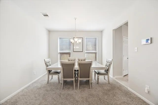 a view of a dining room with furniture and window