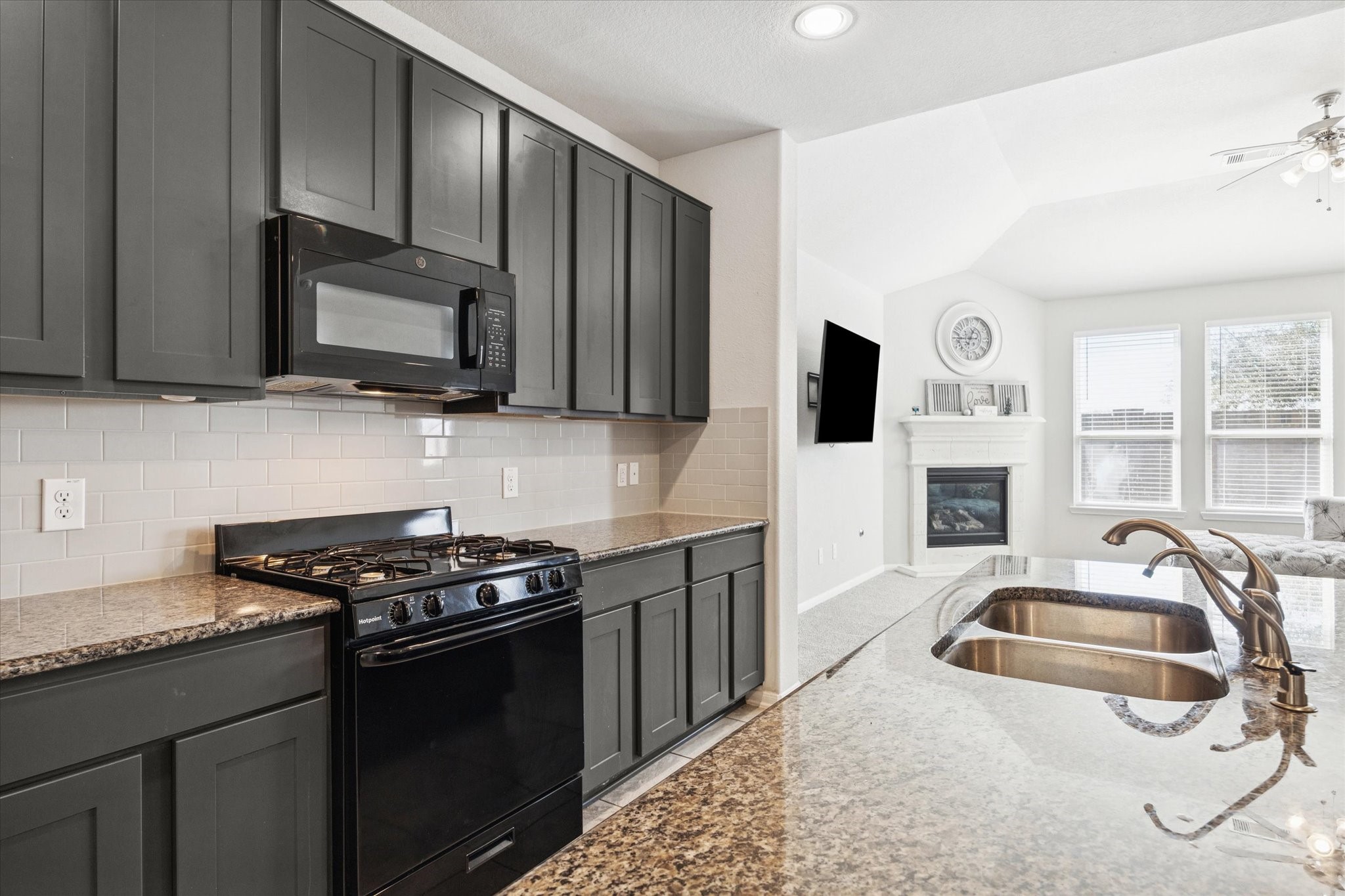 322 Upland Grv Trail Rosharon, TX 77583 - Photo 10 of 36 a kitchen that has a sink and a stove top oven