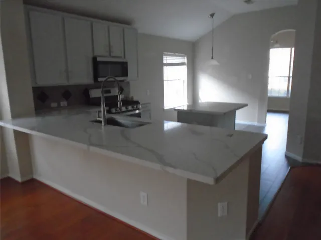 a kitchen with a sink cabinets and a window