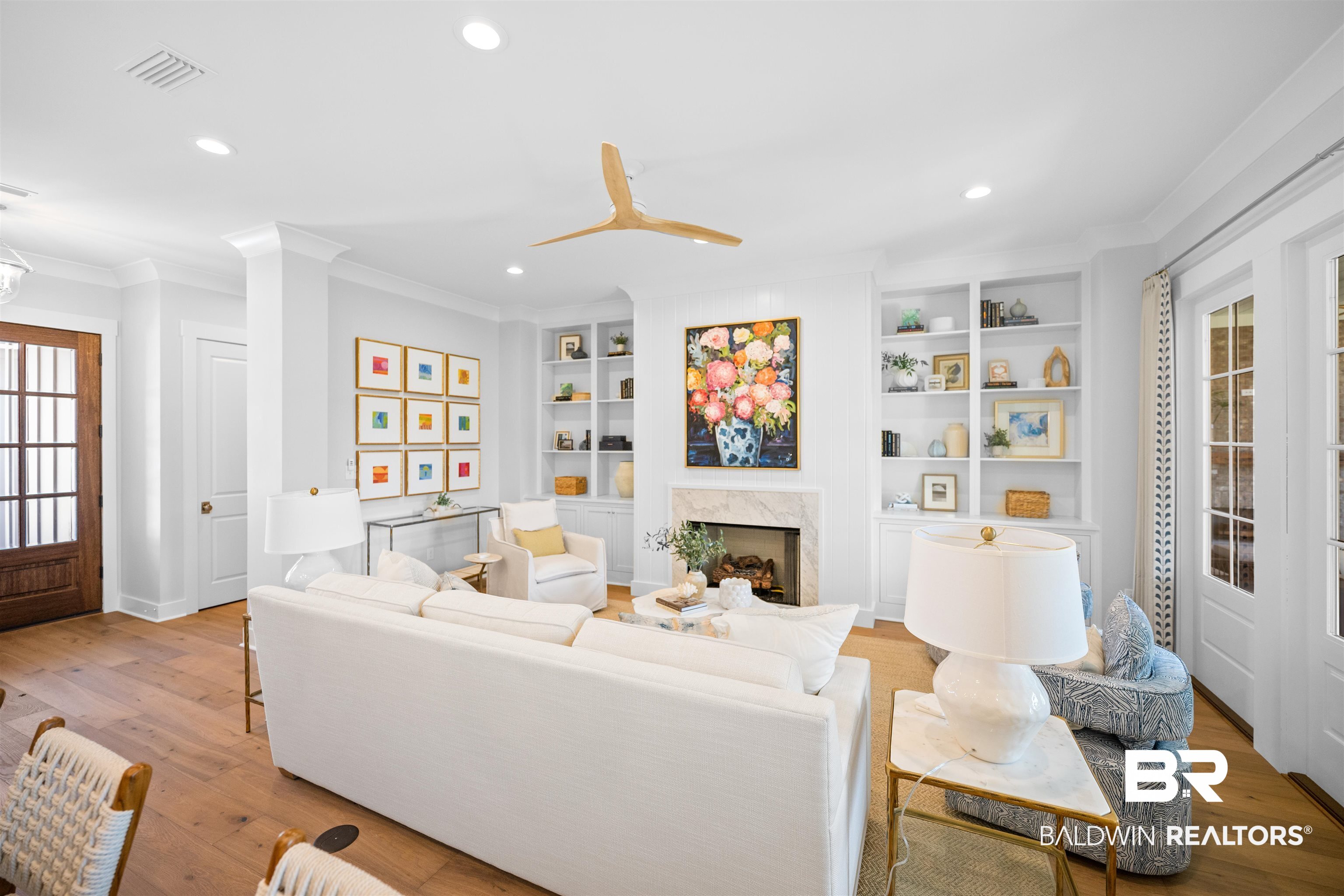 156 Hyacinth Street Fairhope, AL 36532 - Photo 19 of 61 Living room featuring recessed lighting, wood finished floors, a high end fireplace, built in features, and crown molding