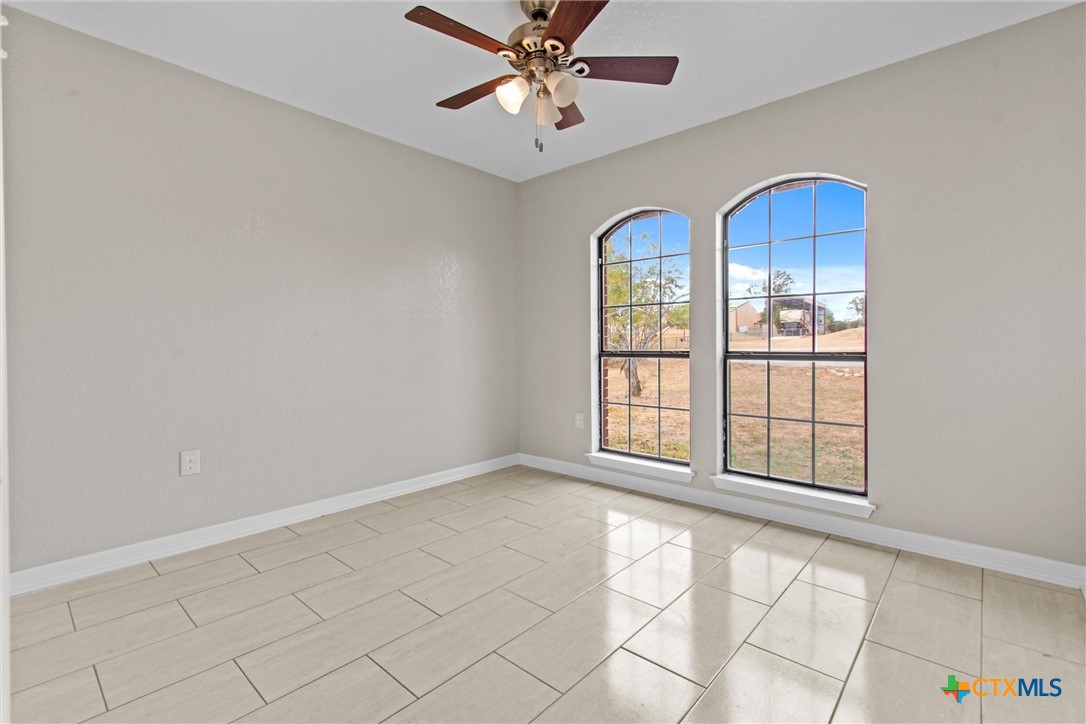 180 County Road 4933 Kempner, TX 76539 - Photo 9 of 24 an empty room with windows and fan