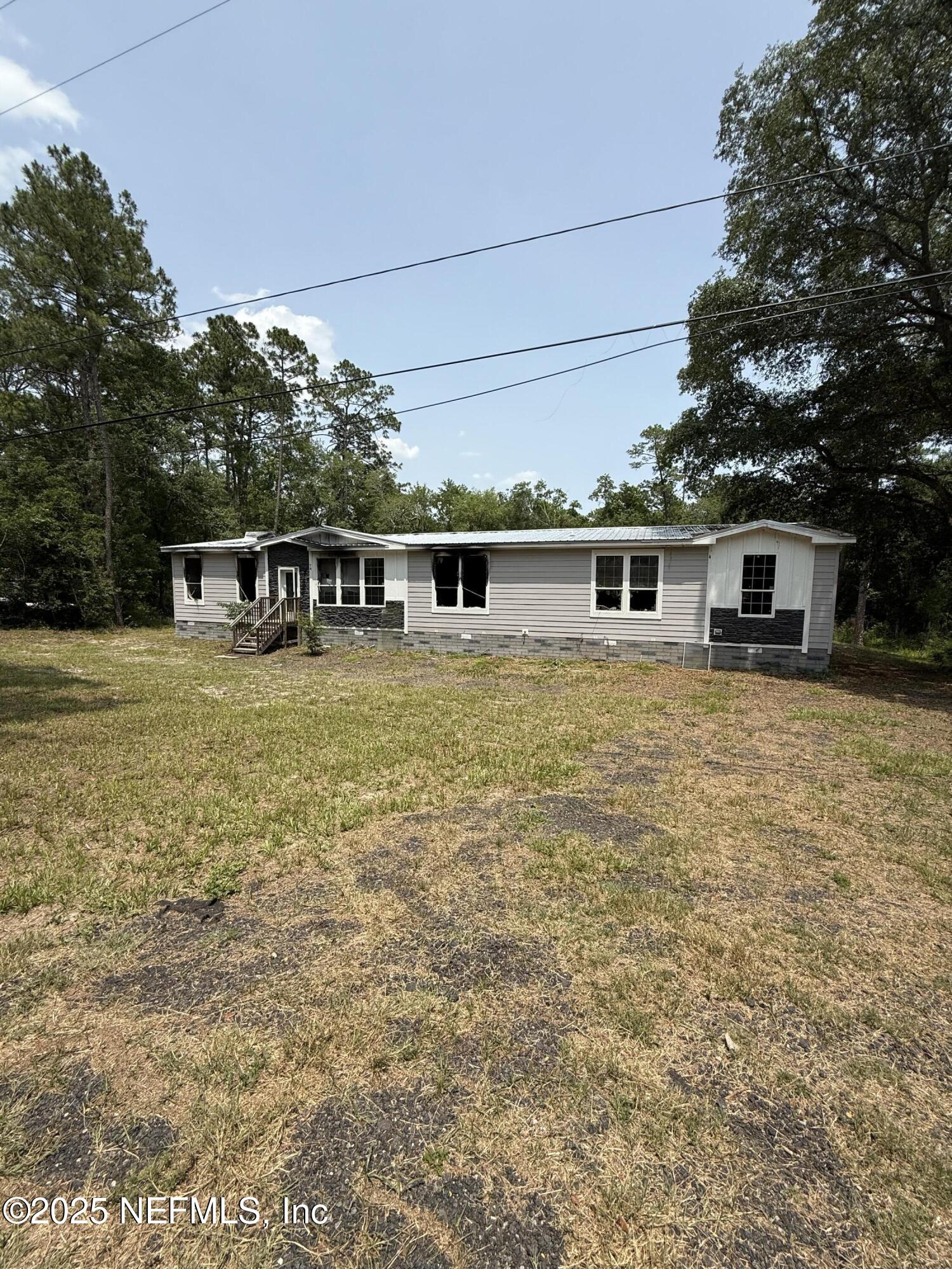 a view of a house with yard and sitting area