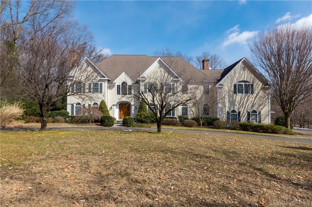 18 Pine Ridge Road Wilton, CT 06897 - Photo 1 of 1 a front view of a house with a yard