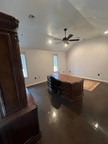 a room with furniture and a ceiling fan