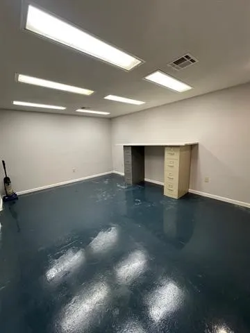 a view of room and hall with wooden floor