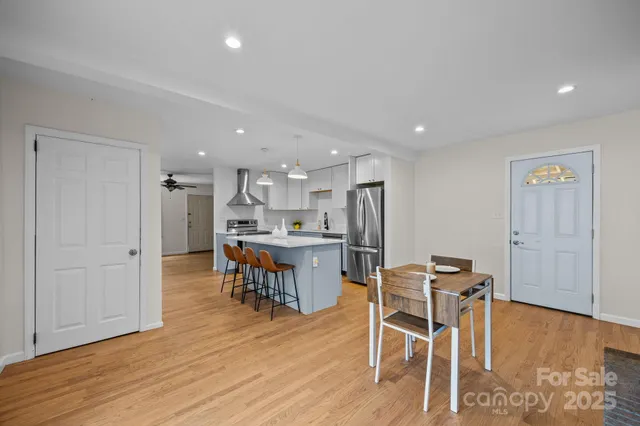 a dining room with furniture and wooden floor