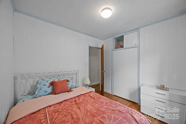 a bedroom with a bed and cabinets
