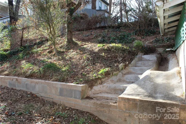 a view of a yard with large trees